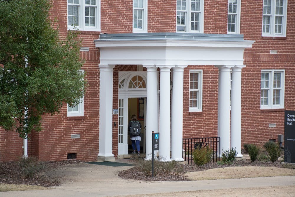 A student walks into Owen residence hall, a dormitory that is in The Quad neighborhood, on Friday, Feb. 9, 2018, in Auburn, Ala.