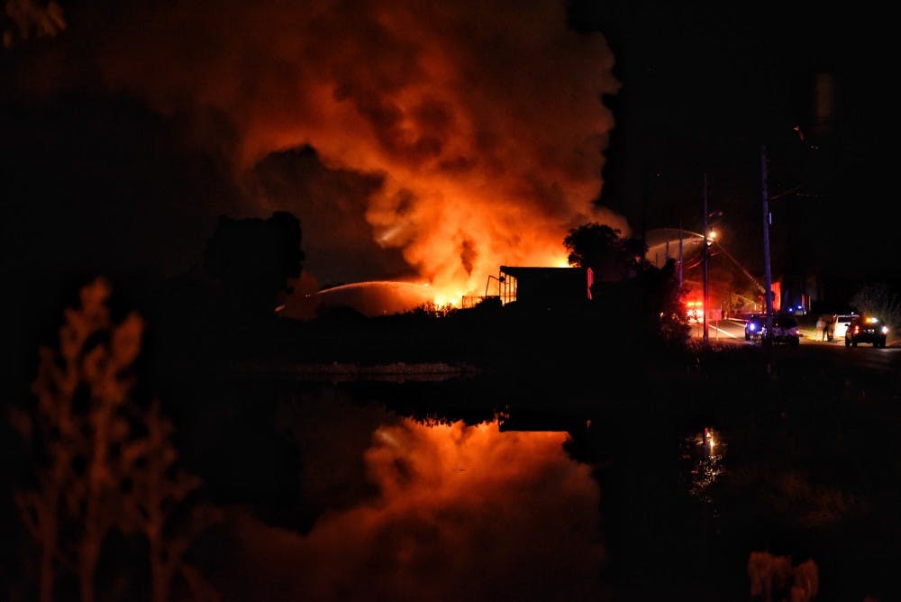 Fire fighters battle a fire at Leshner Mill, Tuesday, Nov. 15, 2016 in Opelika,Ala.