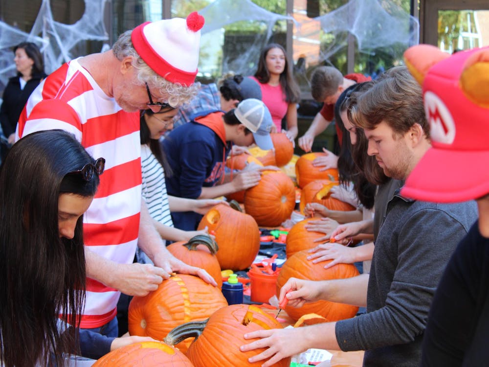 Pumpkin carvers, including one in a Waldo costume, making their pieces at CADC's 37th Annual Pumpkin Carve on Friday, October 31, 20205.