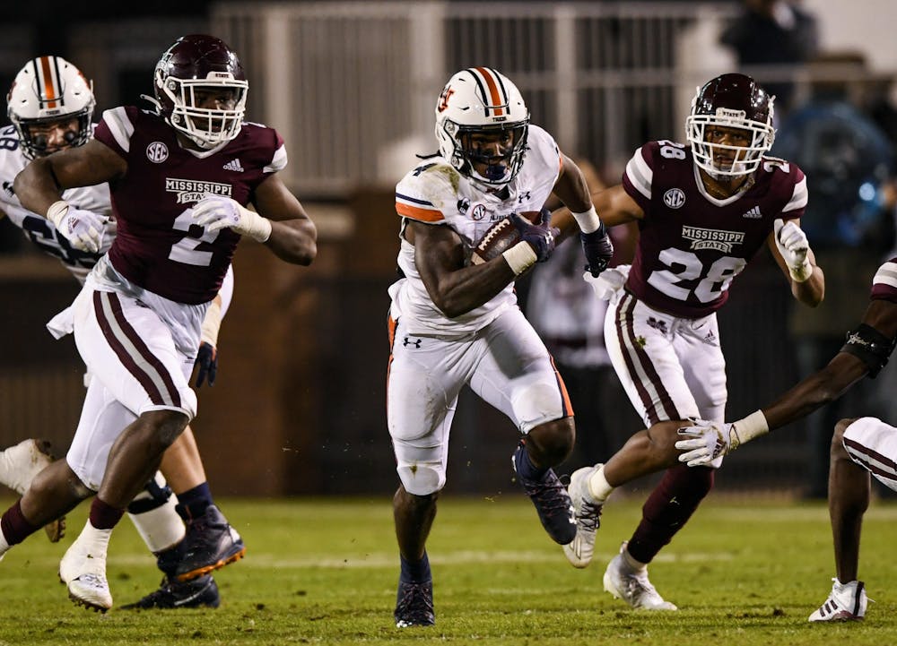 <p>Tank Bigsby (4) chased by defenders during the game between Auburn and Mississippi State at Davis Wade Stadium on Dec 12, 2020; Starkville, Mississippi, USA. Photo via: Todd Van Emst/AU Athletics</p>