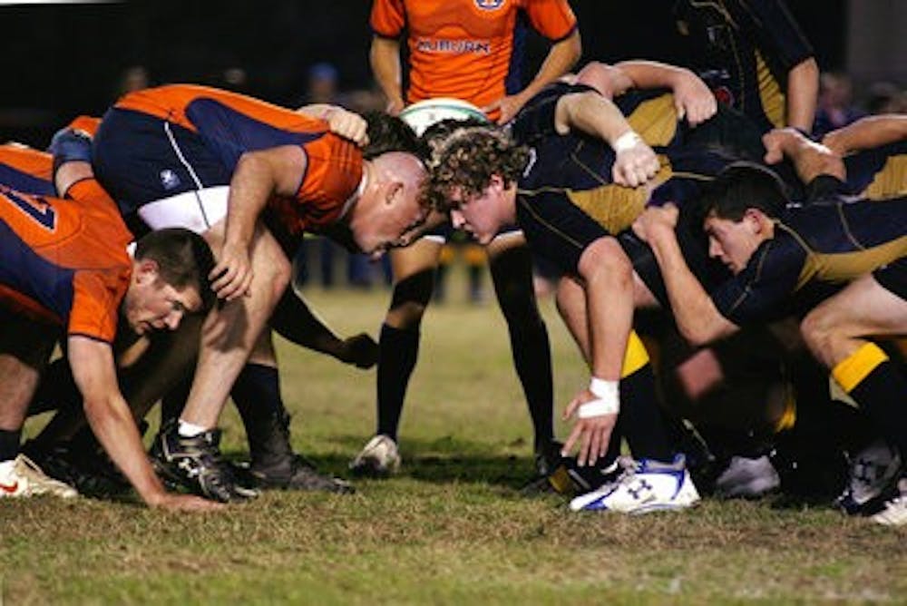 Auburn's flanker Chad Crosson, left, and prop Zach Bolstad prepare for the scrum, which begins a play in rugby. (Rebekah Weaver / Assistant Photo Editor)