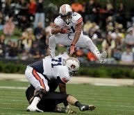 Auburn running back Tre Mason hurdles his way to part of a 16 carry, 85 yard performance. (Todd Van Emst)