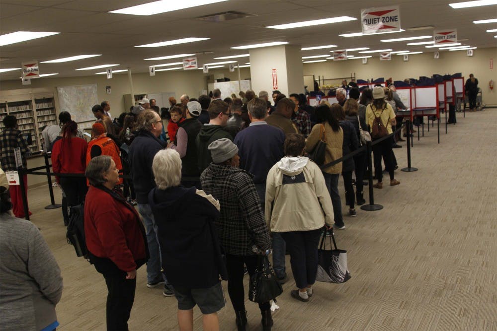 Voters stand in line inside of the  Board of Education on Nov. 2, 2018 to early vote in Cincinnati, Ohio.  (Ernest Coleman/Zuma Press/TNS) 