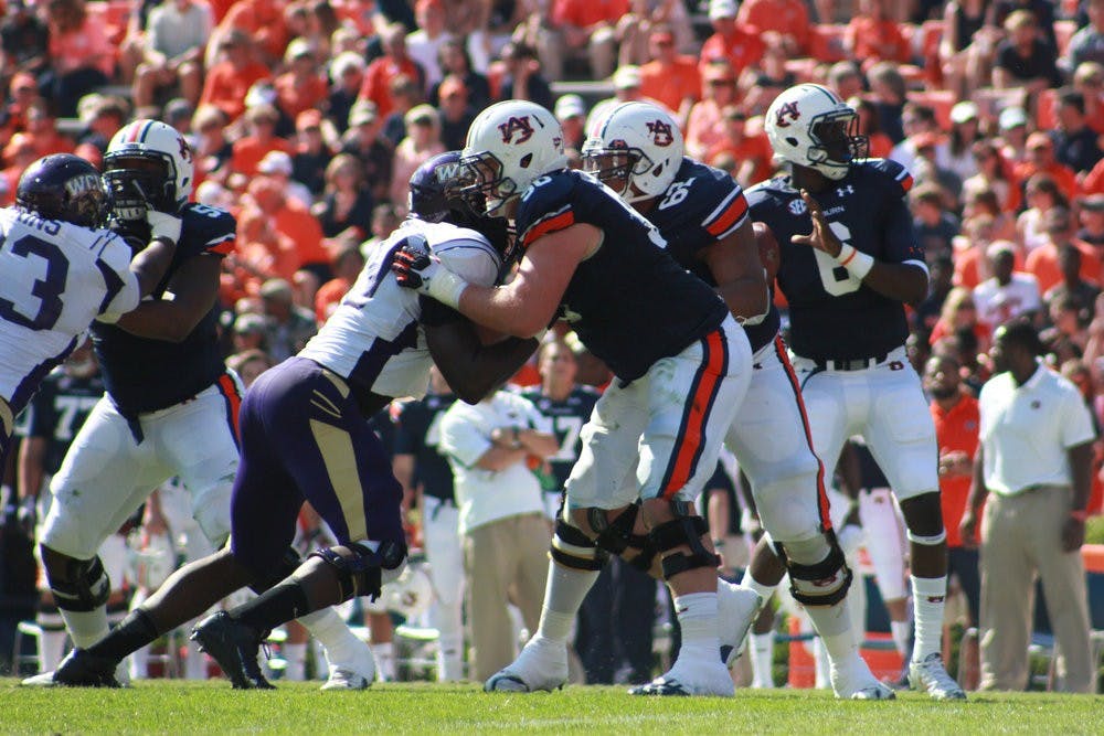 Reese Dismukes blocks Western Carolina player to protect the quarterback. (Jenna Burgess / ASSOCIATE PHOTO EDITOR)