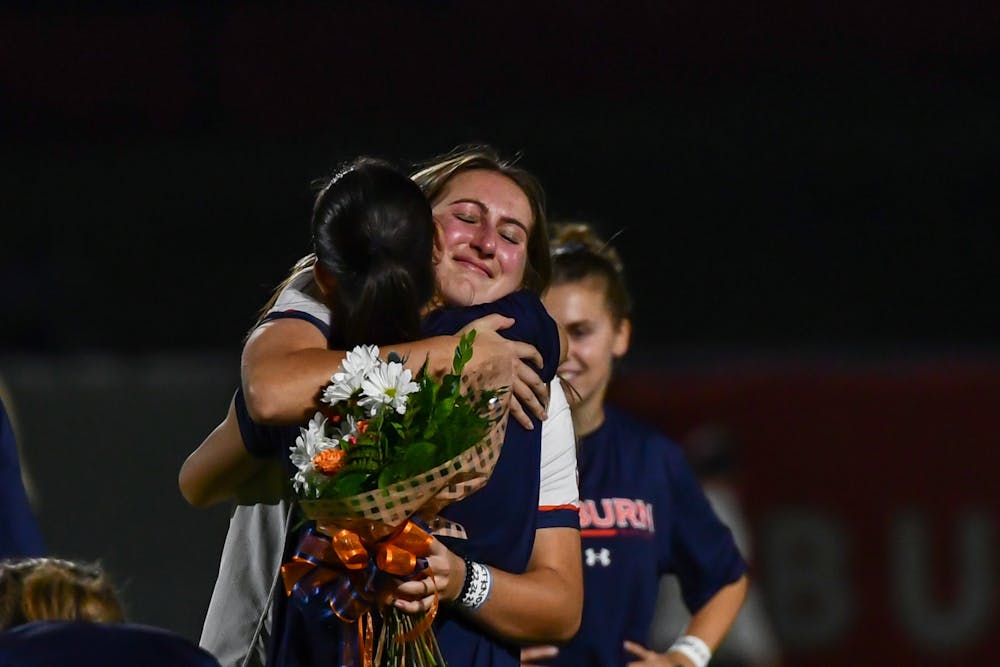 Auburn senior Brooke Berdan embraces a teammate before a matchup against Alabama in the Auburn soccer complex on Oct. 27, 2022.