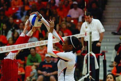 Senior middle blocker Alyssa Davis blocks a shot during Sunday's game against Ole Miss. (Charlie Timberlake / ASSISTANT PHOTO EDITOR)