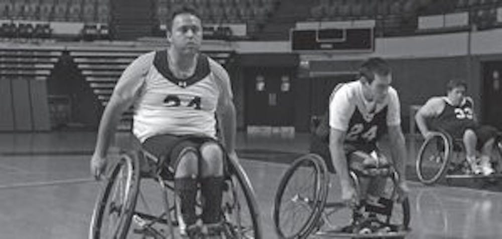 Members of Auburn's wheelchair basketball team practice in the Beard-Eaves Coliseum. From left to right are players Josh Gess, Phillip Crain and Scott Scroggins, who arrive at 6 a.m. every weekday to practice. (Rebecca Croomes / PHOTO EDITOR)