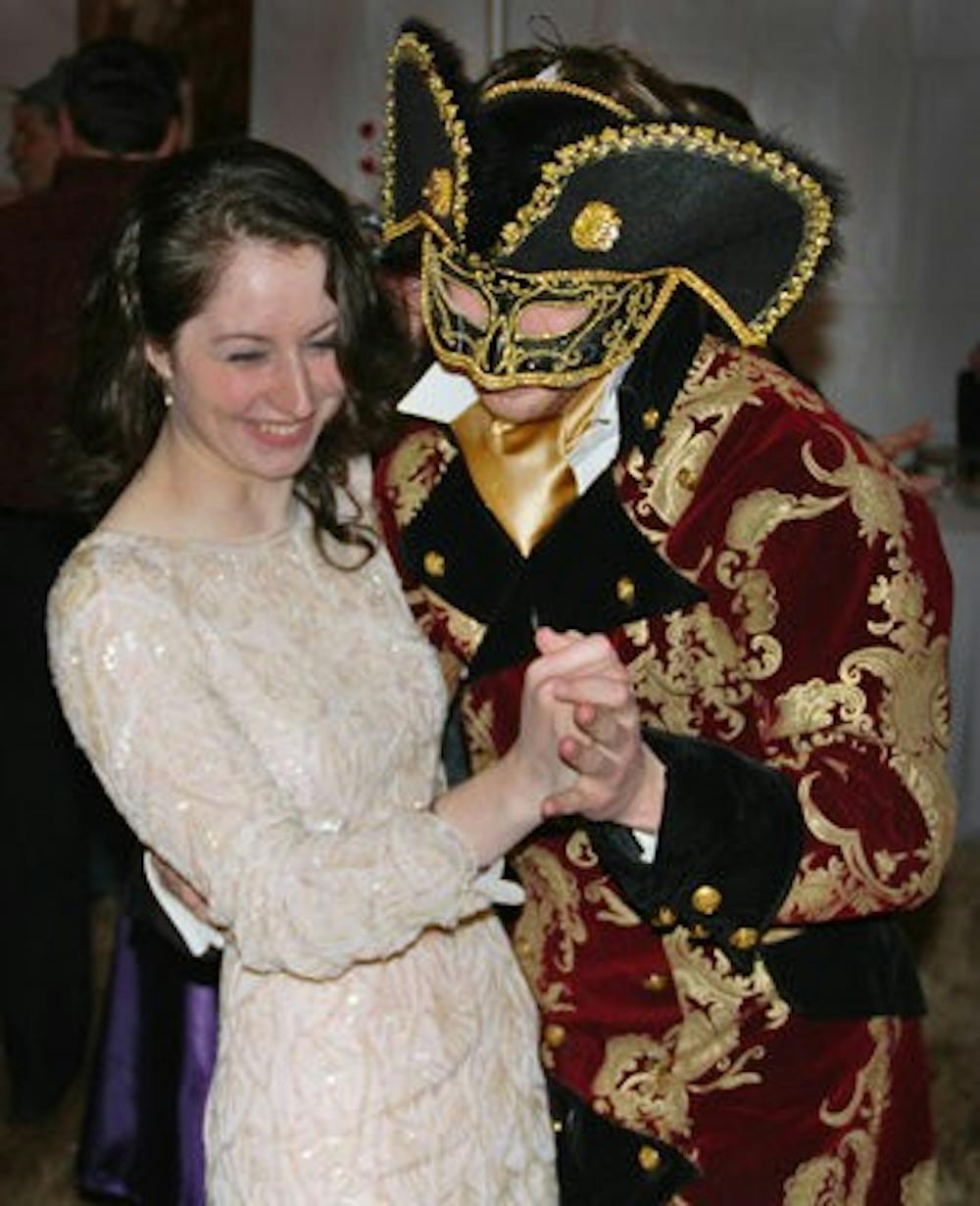 Kelly Davino and Chase Cox enjoy a night of dancing at the Carnivale masquerade ball Feb. 12. (Daniel Friday / Photo Staff)