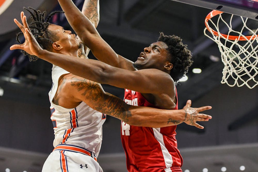 Auburn guard Allen Flanigan (22) moves to score a two-pointer in a matchup against Alabama in Neville Arena on Feb. 11, 2023.