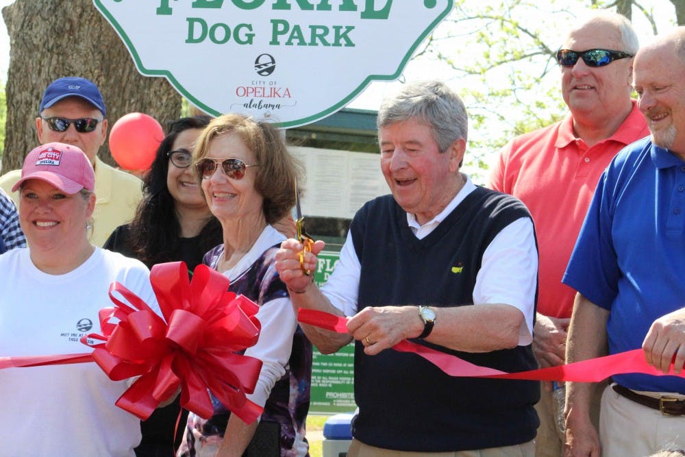 Opelika Mayor Gary Fuller cuts the ribbon&nbsp;at the Opelika Dog Park grand opening&nbsp;on Saturday, April 14, 2018, in Opelika, Ala.