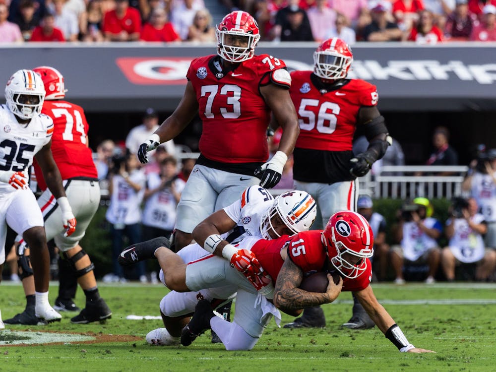 Auburn's Keldric Faulk sacks Georgia quarterback Carson Beck during the second quarter of Auburn at Georgia on October 5, 2024. 