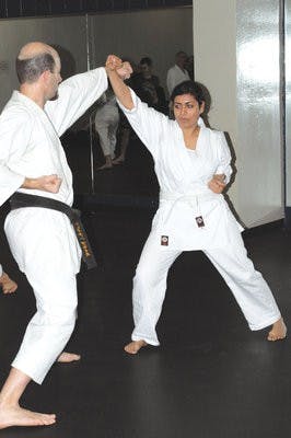 Shannon Price and Dilbur Arsiwalla participate in a partner exercise that combines defensive tactics and offensive movements at practice Thursday. (Christen Harned / ASSISTANT PHOTO EDITOR)