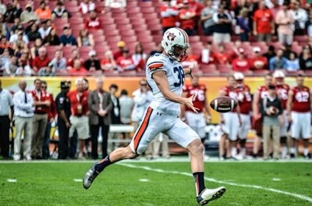 Daniel Carlson kicks the ball to Wisconsin. (Raye May | Photo Editor)