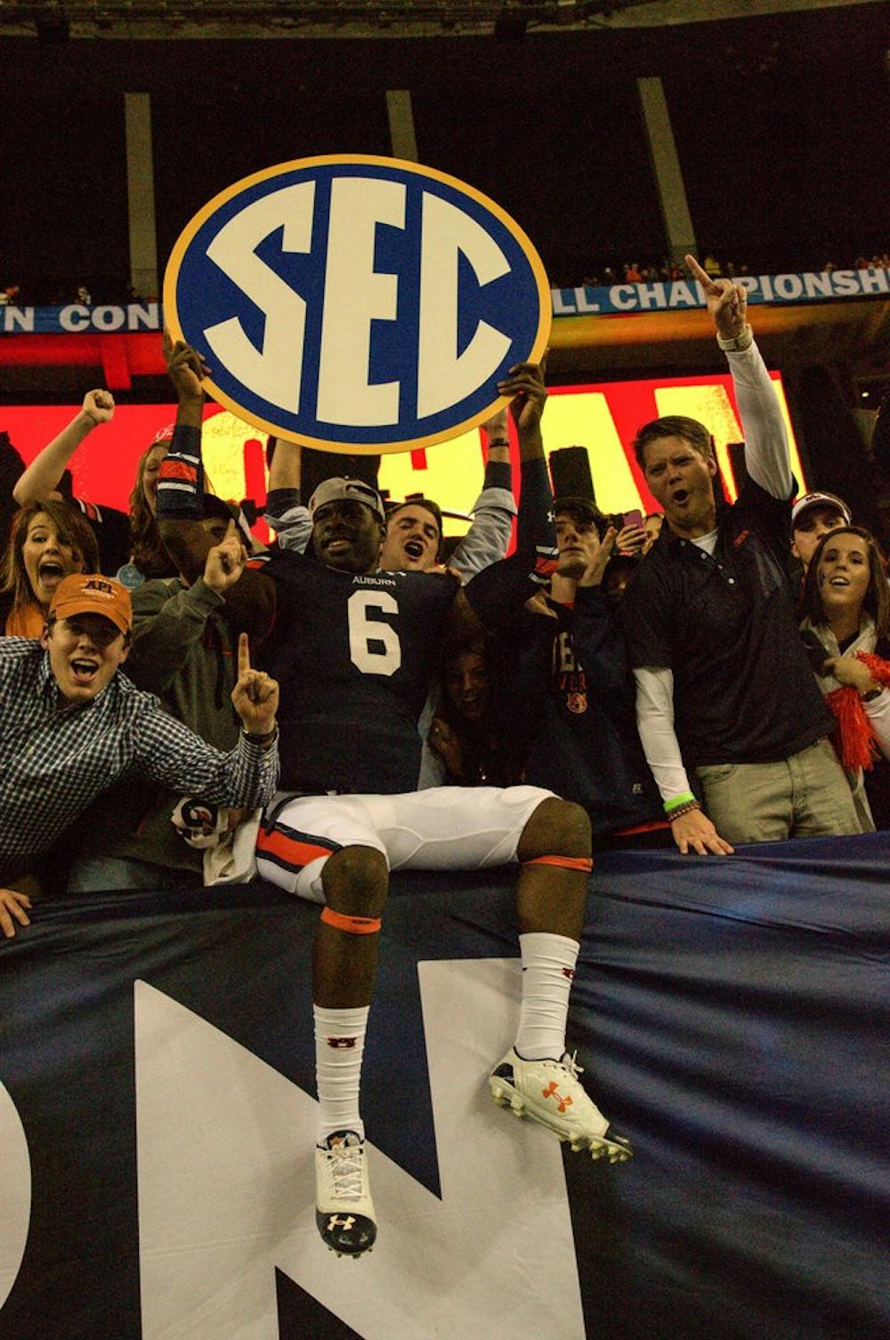 <p>Jeremy Johnson celebrates with students after winning the SEC title. (Raye May | Managing Editor) </p>