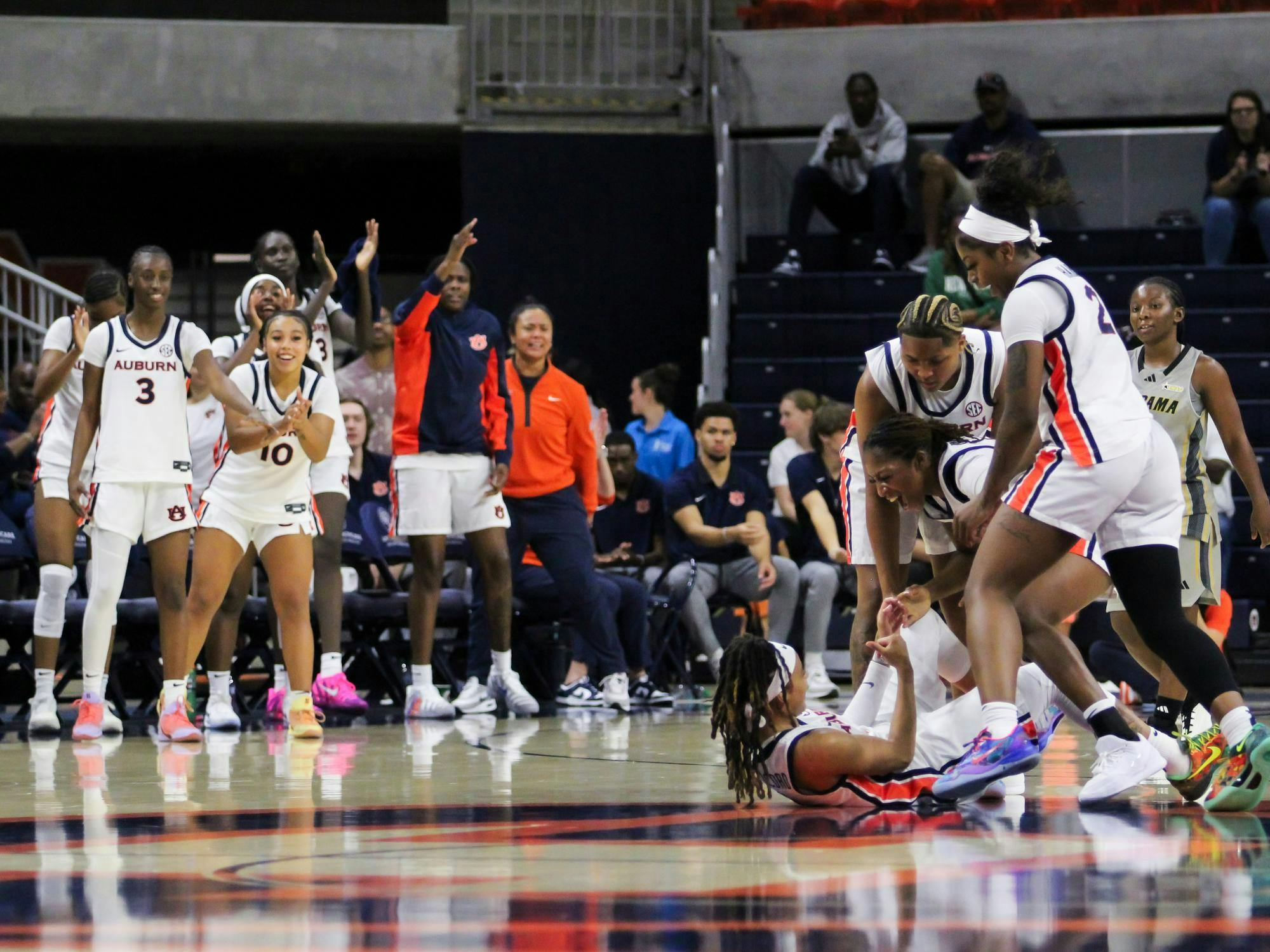The Auburn Women's Basketball team celebrates Mya Petticord after she makes a three pointer and gets fouled by Alabama State at Neville Arena in Auburn, Ala. on Nov. 8, 2025.