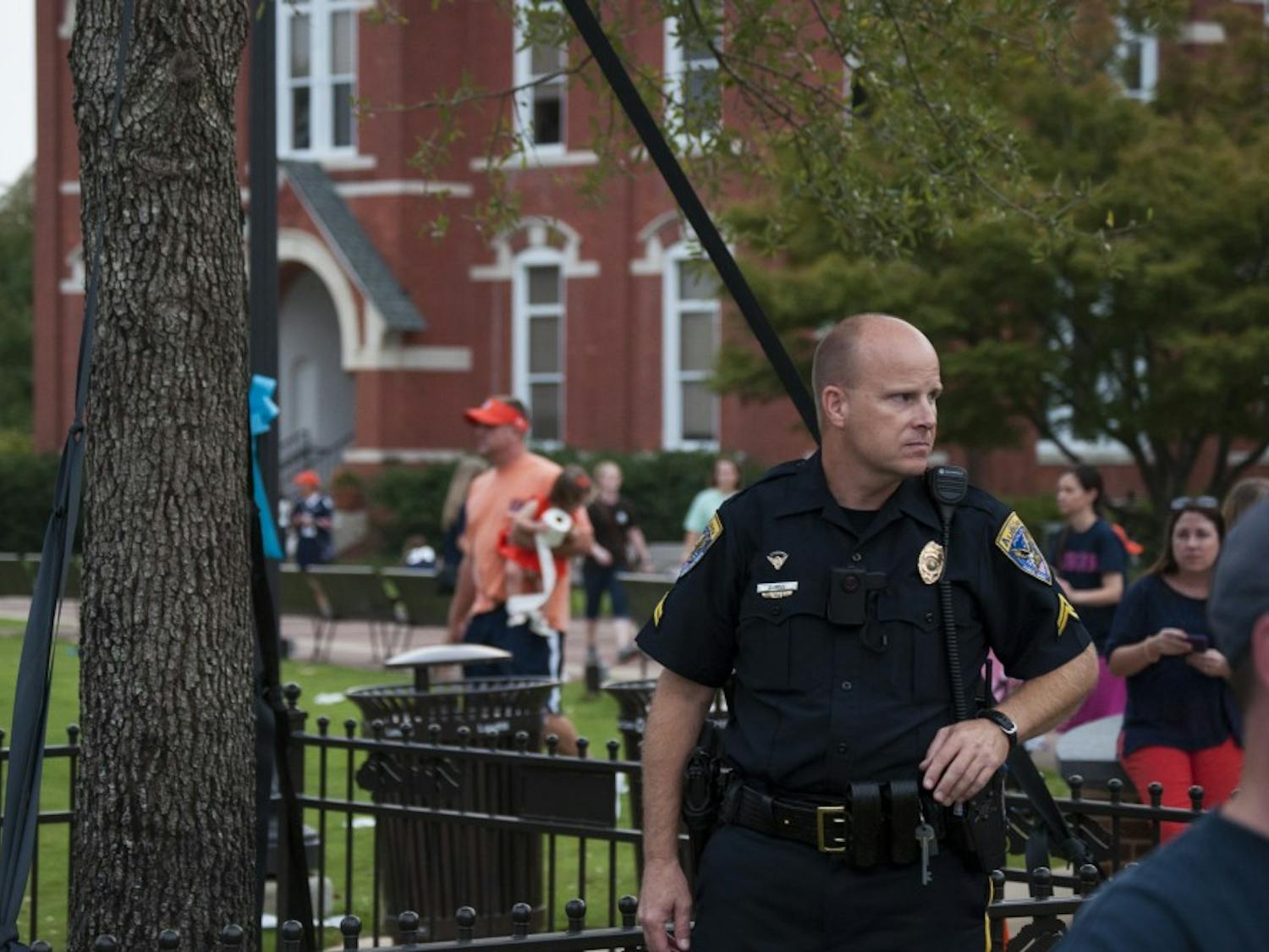 Police officers protecting Toomer's Oaks. Fans will be able to roll the trees next year. (Jordan Hays | Managing Editor)