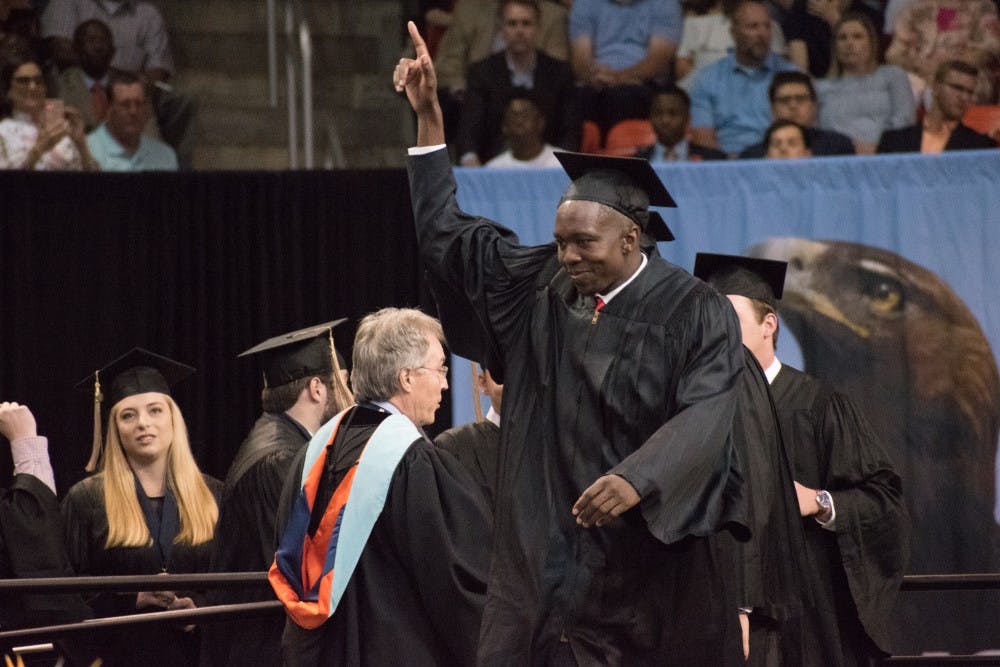 A graduate walks across the stage on Sunday, May 6, 2018, in Auburn, Ala.