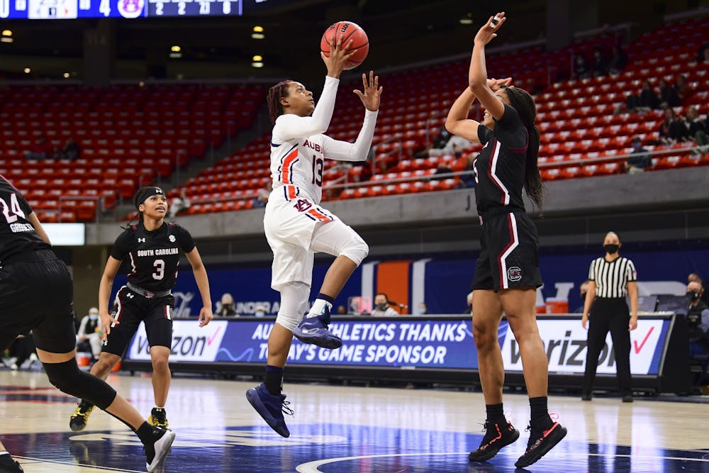 Auburn Tigers guard Kira Lowery (13) shoots as South Carolina Gamecocks forward Victaria Saxton (5) defends during the game between Auburn and South Carolina at Auburn Arena on Feb 4, 2021; Auburn, AL, USA. Photo via: Shanna Lockwood/AU Athletics
