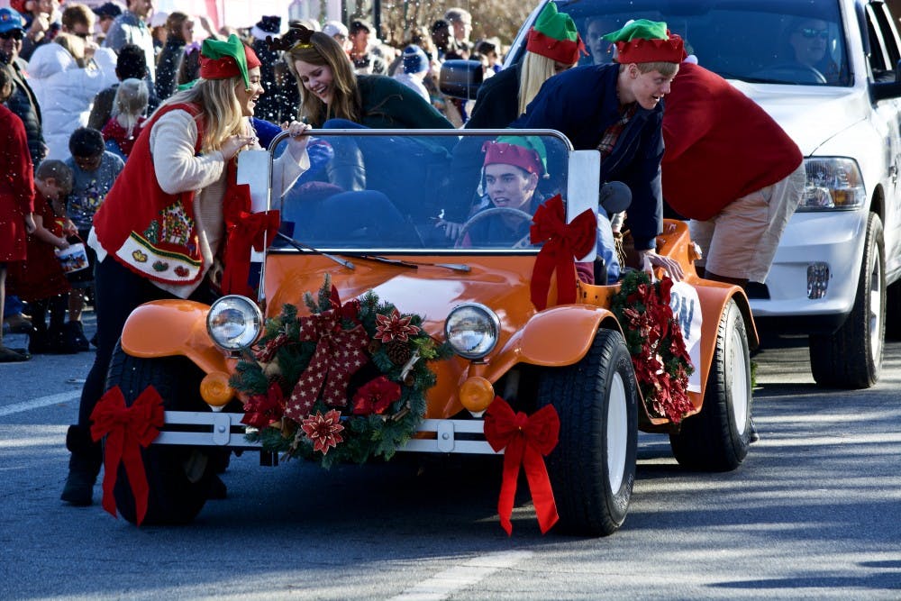 Members of&nbsp;Auburn University SGA jump out of their car to walk&nbsp;during the annual Auburn Christmas Parade, On Sunday, Dec. 10, 2017.