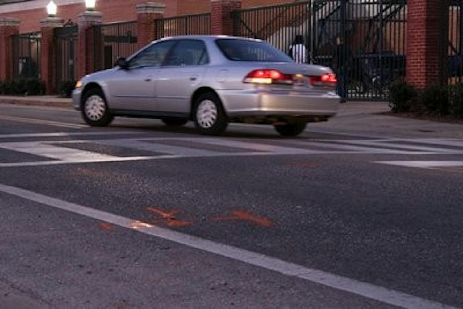 The orange lines signify where the car was stopped after it hit the pedestrian. Blakeley Sisk / PHOTO EDITOR