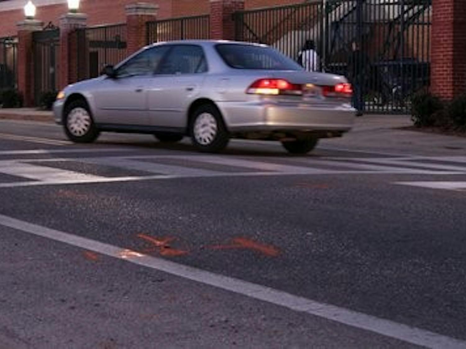 The orange lines signify where the car was stopped after it hit the pedestrian. Blakeley Sisk / PHOTO EDITOR
