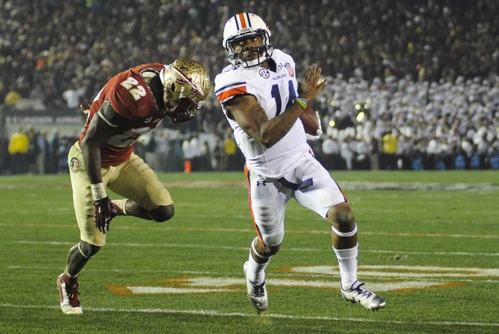 Auburn quarterback Nick Marshall (14) runs for a  touchdown against Florida State, Pasadena, Calif., Jan. 6, 2014. (Zach Bland / Assistant Photo Editor)