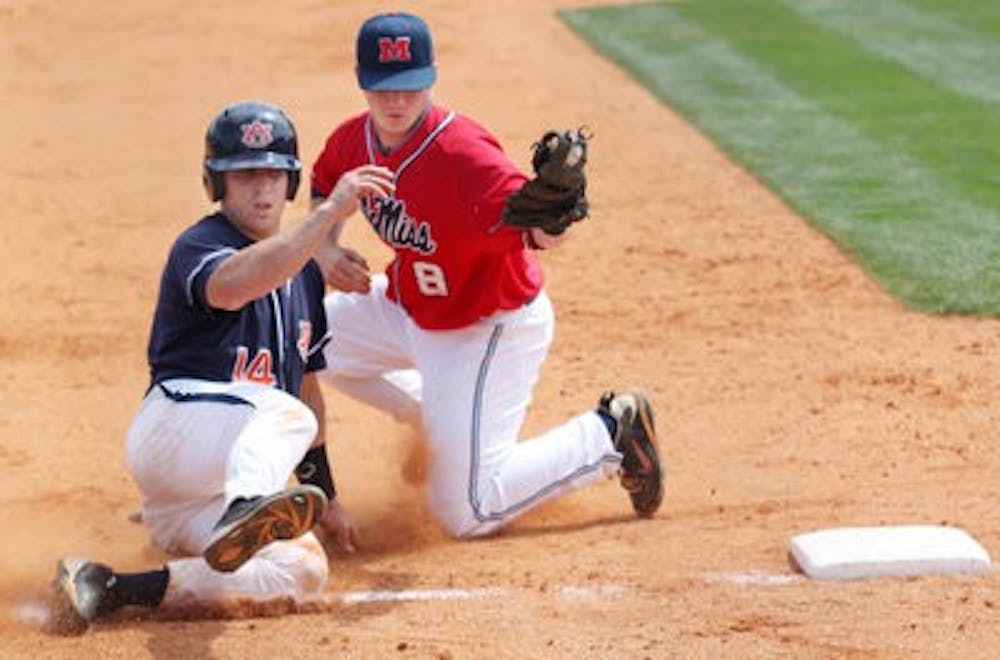 Senior Tony Caldwell slides to third as Ole Miss' Austin Anderson kneels to tag him out at the game Saturday. Auburn won the series 2-1. (Emily Adams / Photo Editor)
