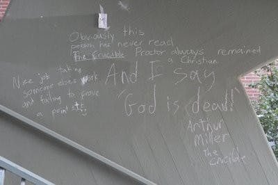 Some chalk drawings, like those in the stairwell of the Haley Center, have turned into forums for theological debate. (Christen Harned / Assistant Photo editor)