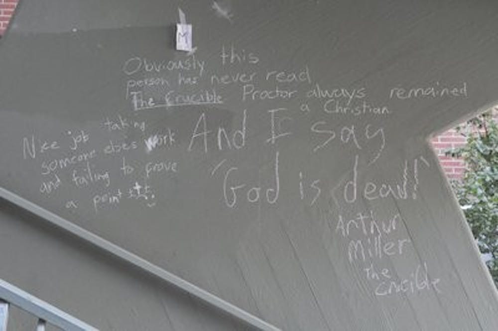 Some chalk drawings, like those in the stairwell of the Haley Center, have turned into forums for theological debate. (Christen Harned / Assistant Photo editor)