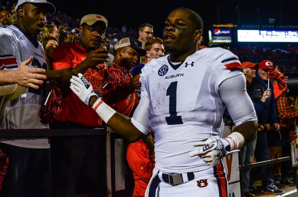 D'haquille Williams high-fives Auburn fans after defeating Kansas State Thursday.

Raye May / PHOTO EDITOR