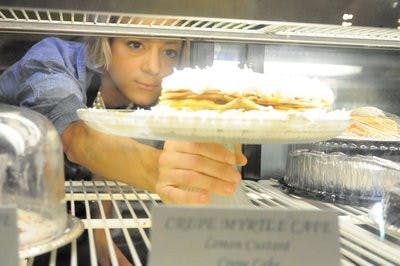 Jamie Krywicki, head pastry chef, returns her lemon custard crepe cake to the display. (Christen Harned /  ASSISTANT PHOTO EDITOR)