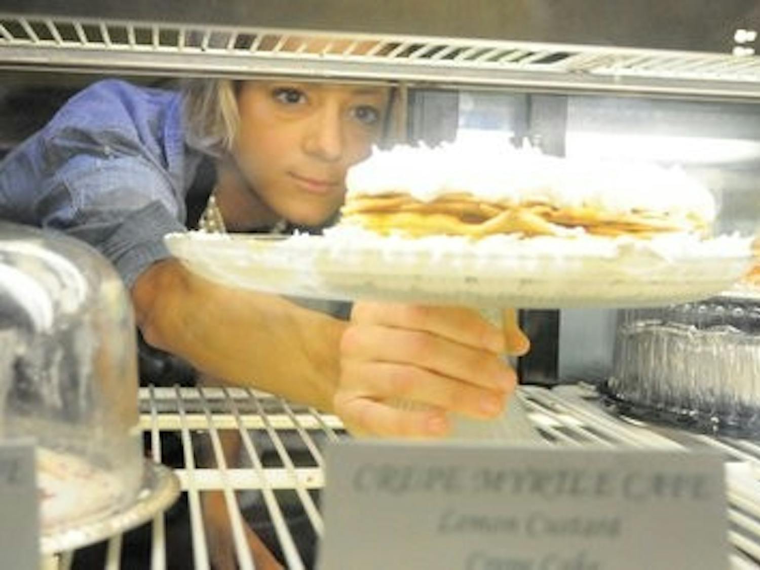 Jamie Krywicki, head pastry chef, returns her lemon custard crepe cake to the display. (Christen Harned /  ASSISTANT PHOTO EDITOR)