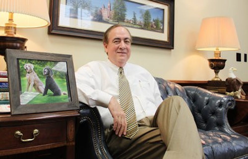 Emily Adams / PHOTO EDITOR



President Jay Gogue sits next to a picture of his two dogs in his office.