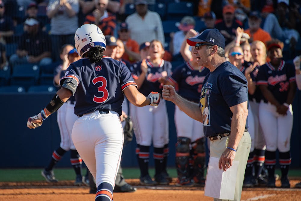 <p>Icess Tresvik (3) fist-bumping Auburn Tigers' assistant coach Eugene Lenti on her way to home plate after hitting a home run in their second game against the Tennessee Lady Vols on March 30, 2024.</p>