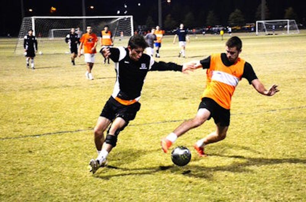 Kyle Kimel challenges Wes Drenning during practice. (Michael Ontiveros l Contributing Photographer)