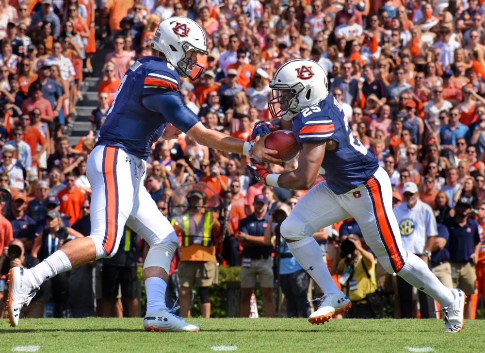 Jarrett Stidham (8) hands the ball off to Shaun Shivers (25) during Auburn football vs. LSU on Saturday, Sept. 15, in Auburn, Ala.