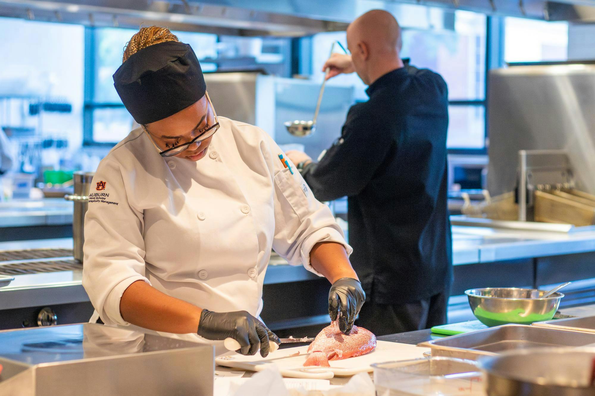 A lab student works with a fish at the Tony & Libba Rane Culinary Science Center on Sept. 24, 2025.