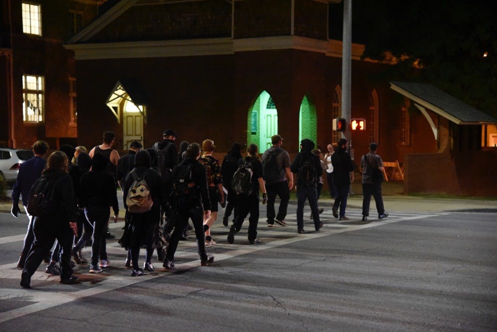 A crowd of students walks across South College Street on Tuesday, April 18, 2017 in Auburn, Ala.&nbsp;