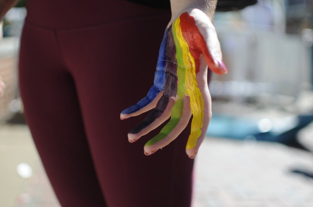 <p>Nairika Hough, a sophomore in graphic design, paints her hand&nbsp;to celebrate Pride Week with&nbsp;Spectrum on Wednesday, Oct. 5, 2016 at Haley Concourse.</p>