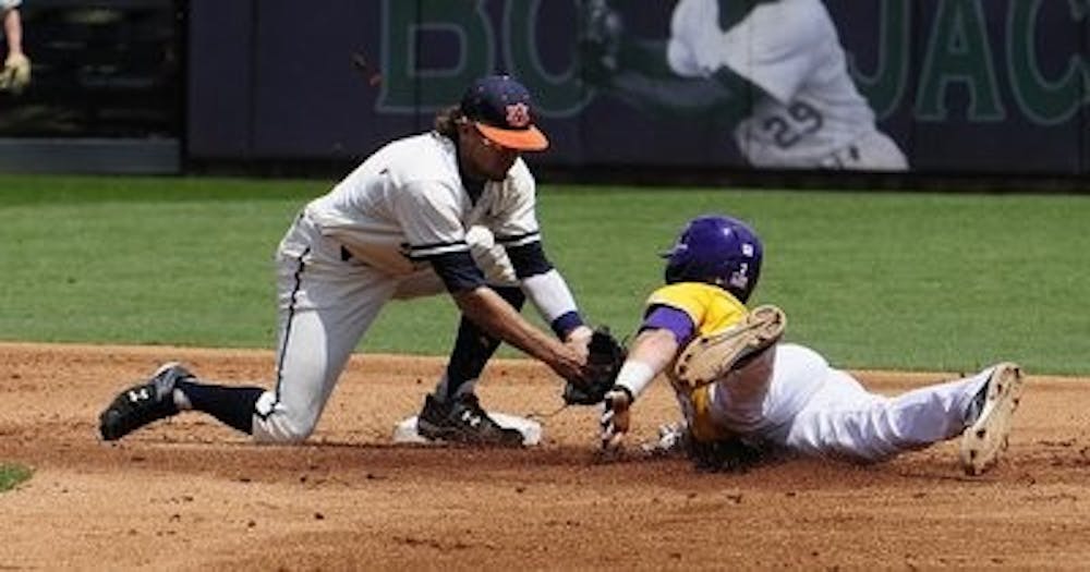 Auburn's Damon Haecker makes the tag at second base on LSU's Tyler Moore on Saturday, May 17, 2014 in Auburn, Ala. (Anthony Hall / Auburn Athletics)