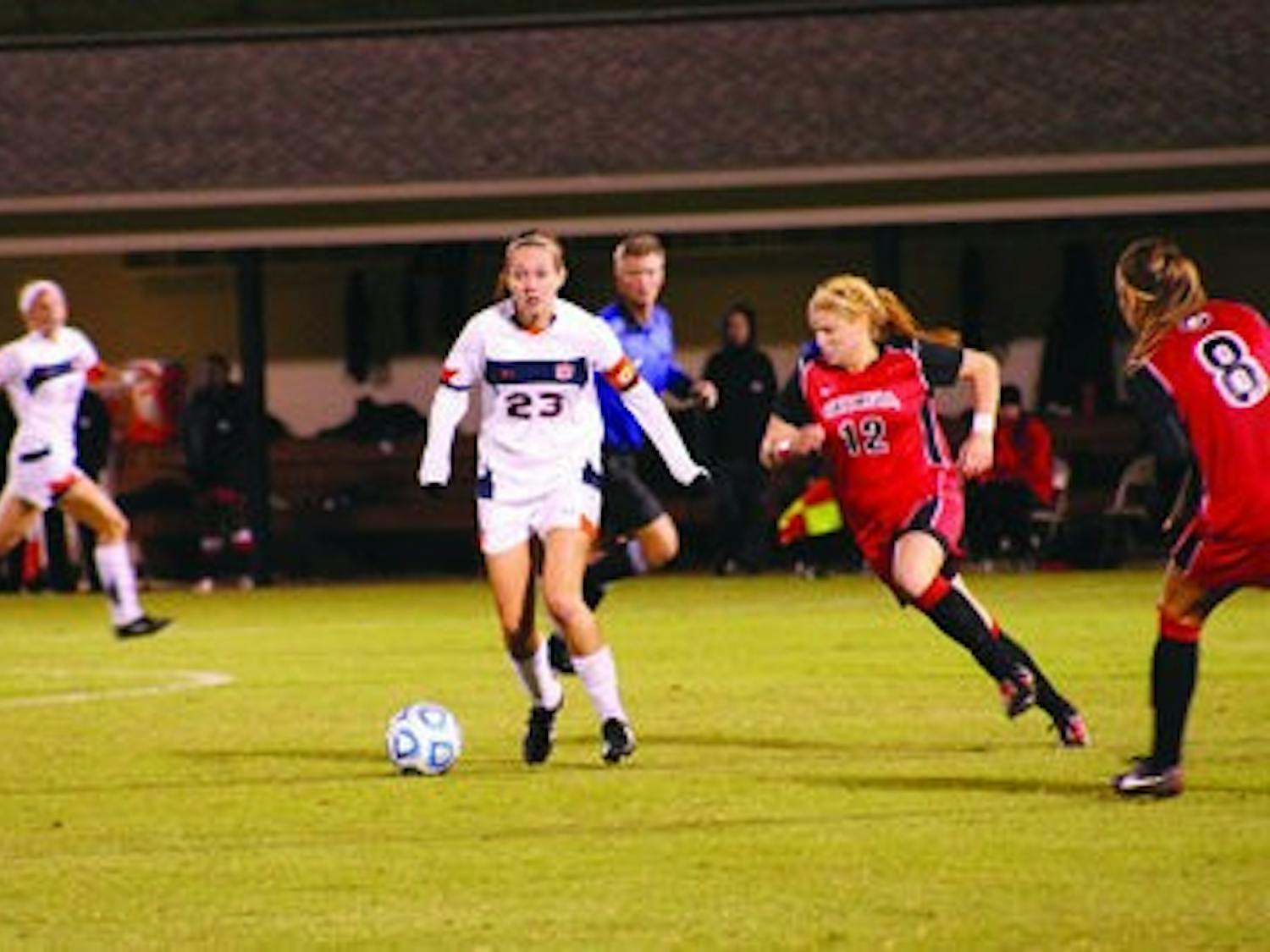 Senior midfielder Katy Frierson keeps the ball from Georgia's Susannah Dennis and Jamie Pollock. (Alex Sager / ASSOCIATE PHOTO EDITOR)