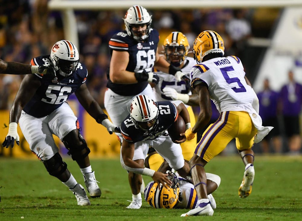 <p>Oct 2, 2021; Baton Rouge, LA, USA; Jarquez Hunter (27) between Auburn and Louisiana State University at Tiger Stadium. Mandatory Credit: Todd Van Emst/AU Athletics</p>