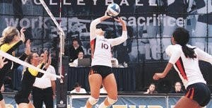 Ciara Richards sets Courtney McDonald for a spike attempt in the Tigers' four set loss to LSU. (Rebecca Croomes / PHOTO EDITOR)