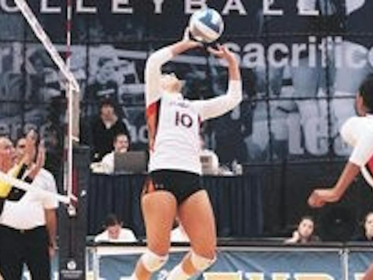 Ciara Richards sets Courtney McDonald for a spike attempt in the Tigers' four set loss to LSU. (Rebecca Croomes / PHOTO EDITOR)