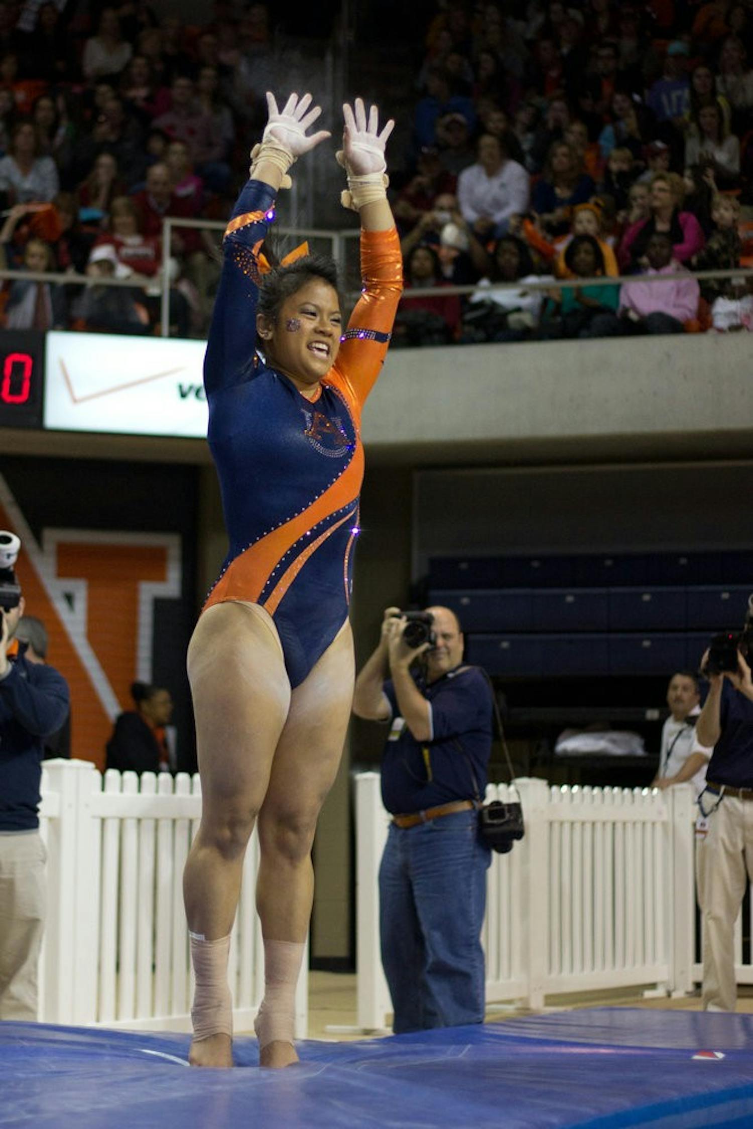 MJ Rott jumps for joy after sticking her landing during the Auburn vs Alabama gymnastics meet. Jenna Burgess / PHOTOGRAPHER