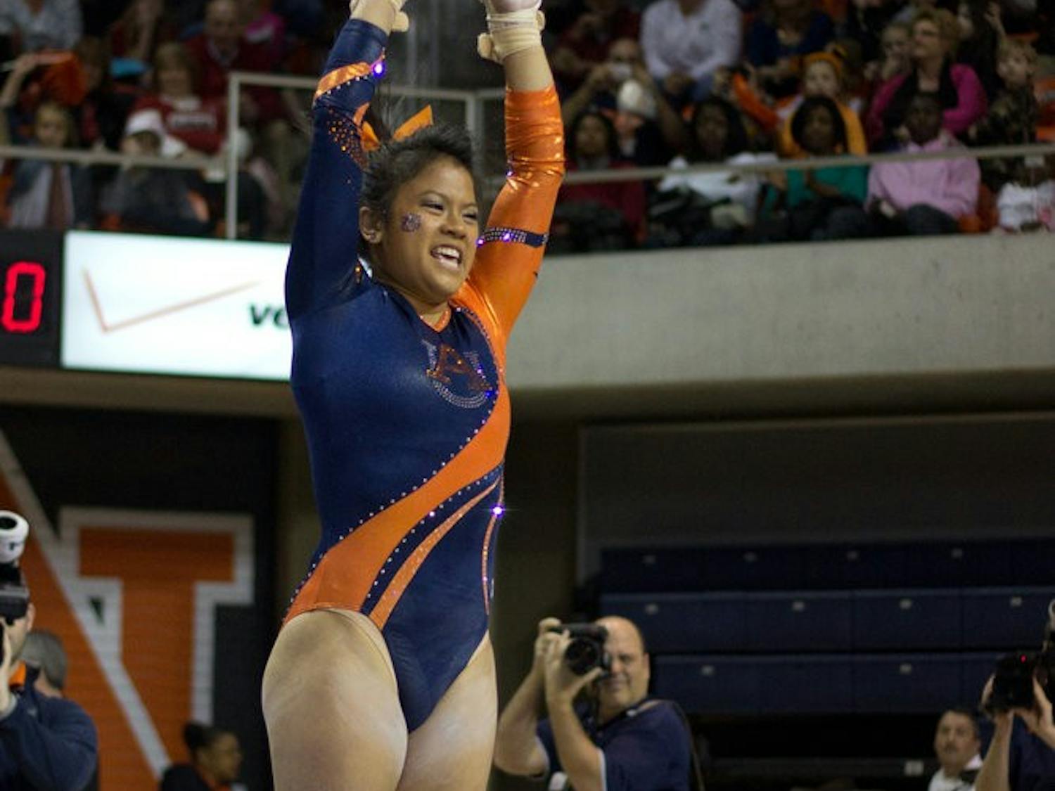 MJ Rott jumps for joy after sticking her landing during the Auburn vs Alabama gymnastics meet. Jenna Burgess / PHOTOGRAPHER