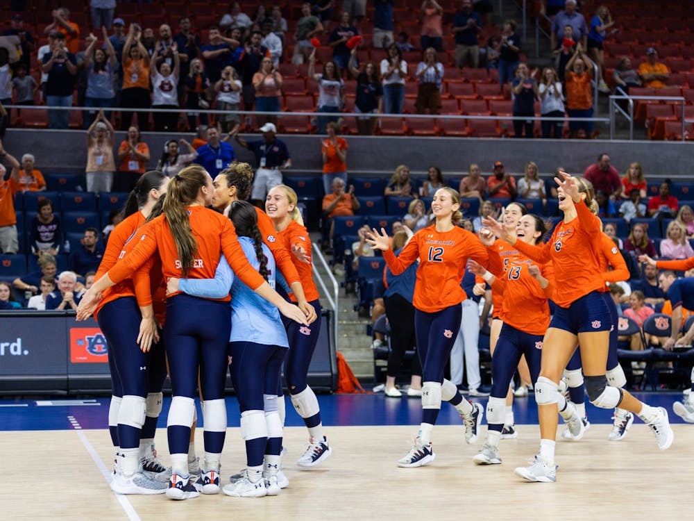 Auburn celebrates after winning set four and clinching a win versus Ole Miss. 
