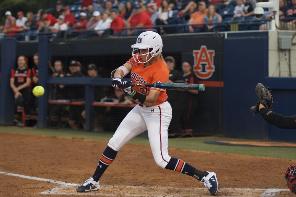 <p>Alyssa Rivera (21) hits the ball during Auburn softball vs. Georgia on March 29, 2019, in Auburn, Ala.&nbsp;</p>