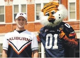 Jesse Teel (left), senior in horticulture, is Auburn's mic-man. (Courtesy of Auburn Cheerleading Squad)