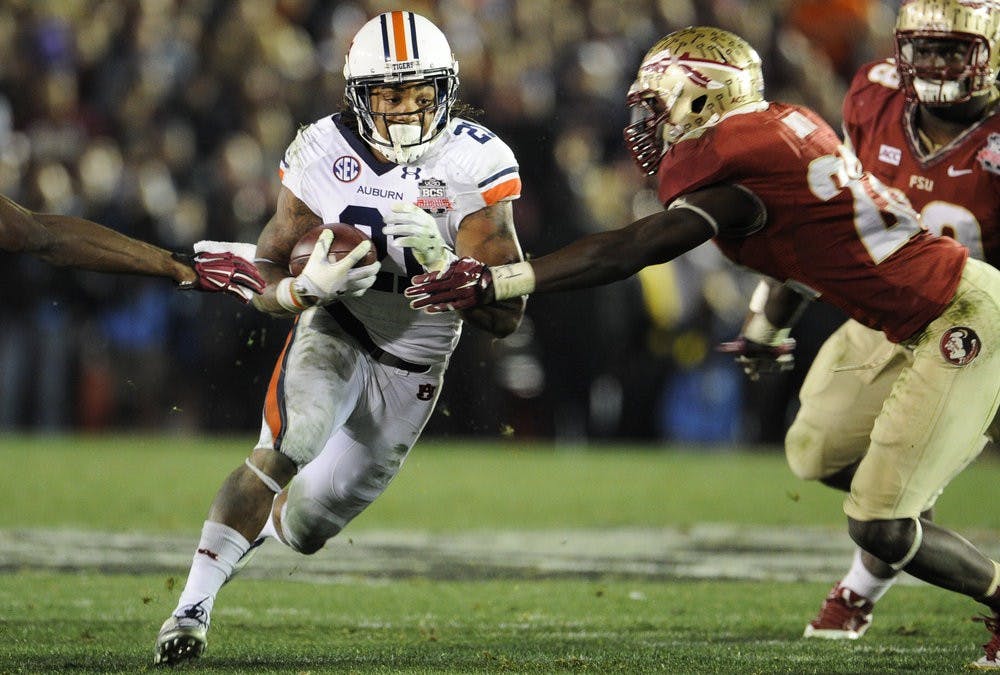 Auburn running back Tre Mason (21) runs the ball 37 yards for a  touchdown to put Auburn ahead of Florida State 31-27 with 1:19 left in the game, Pasadena, Calif., Jan. 6, 2014. (Zach Bland / Assistant Photo Editor)